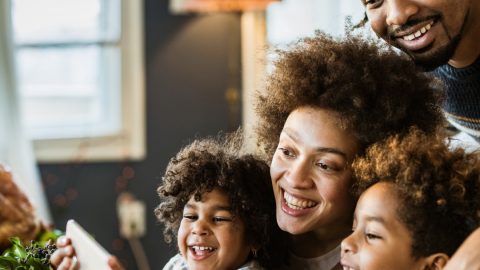 smiling family using iPad