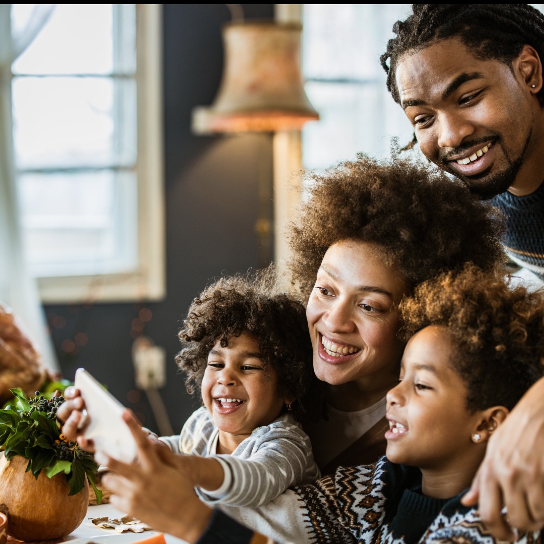 smiling family using iPad