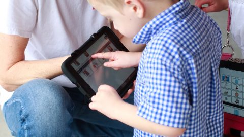 young boy using ipad