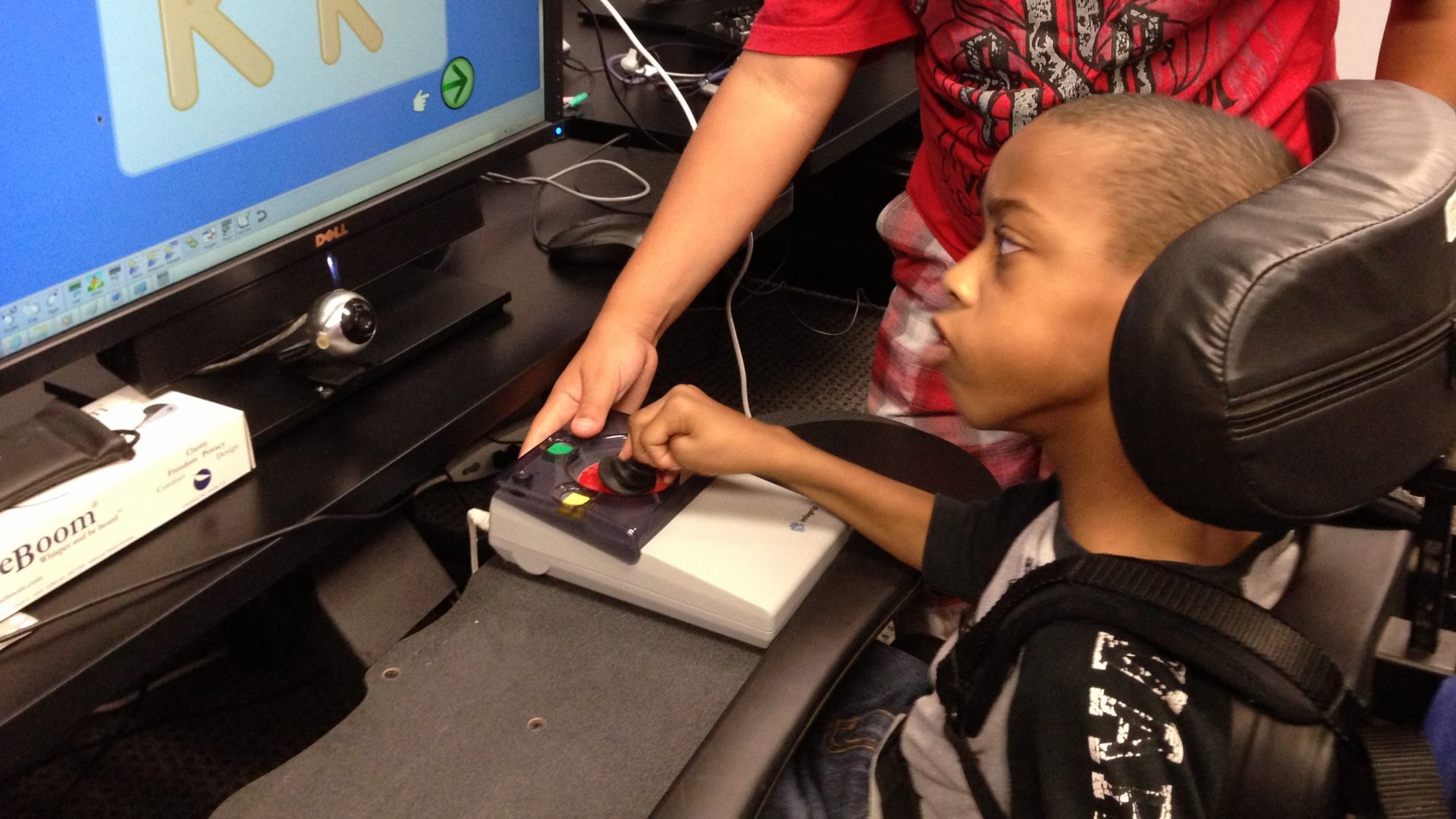 African American boy with Joystick Pro and computer monitor