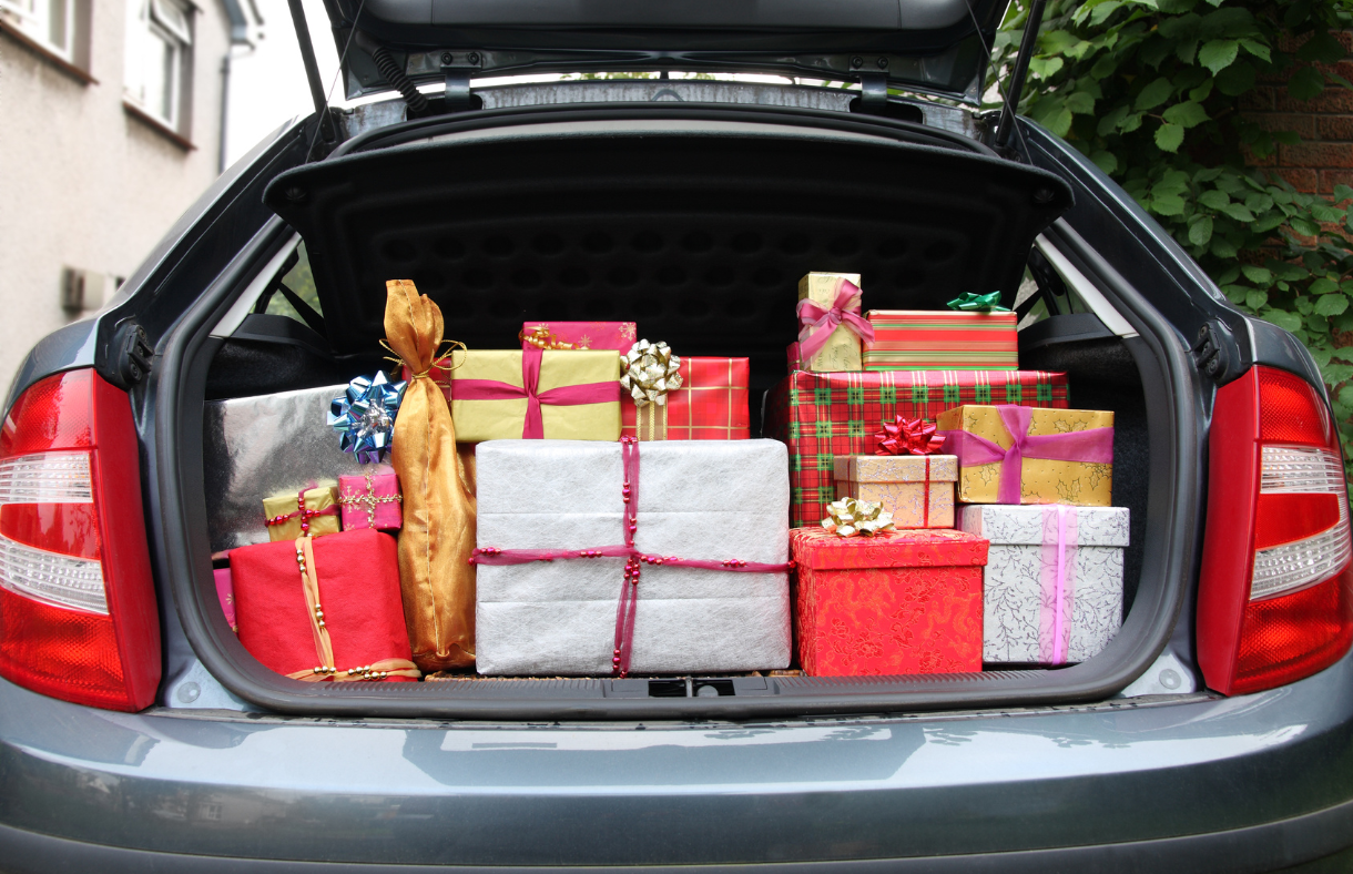 trunk of car filled with Christmas gifts