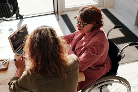 Two ladies sitting in front of laptop