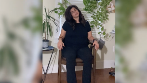 young adult female sitting in chair