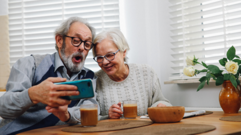 older adult couple using iphone
