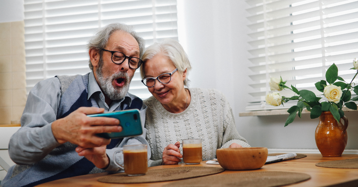 older adult couple using iphone