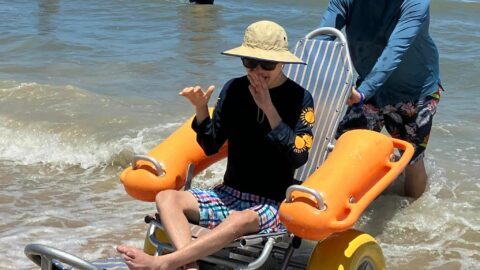 Young man in beach wheelchair