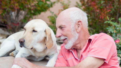 older adult man with dog