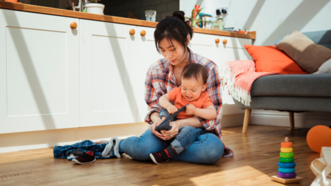 mom holding toddler throwing tantrum