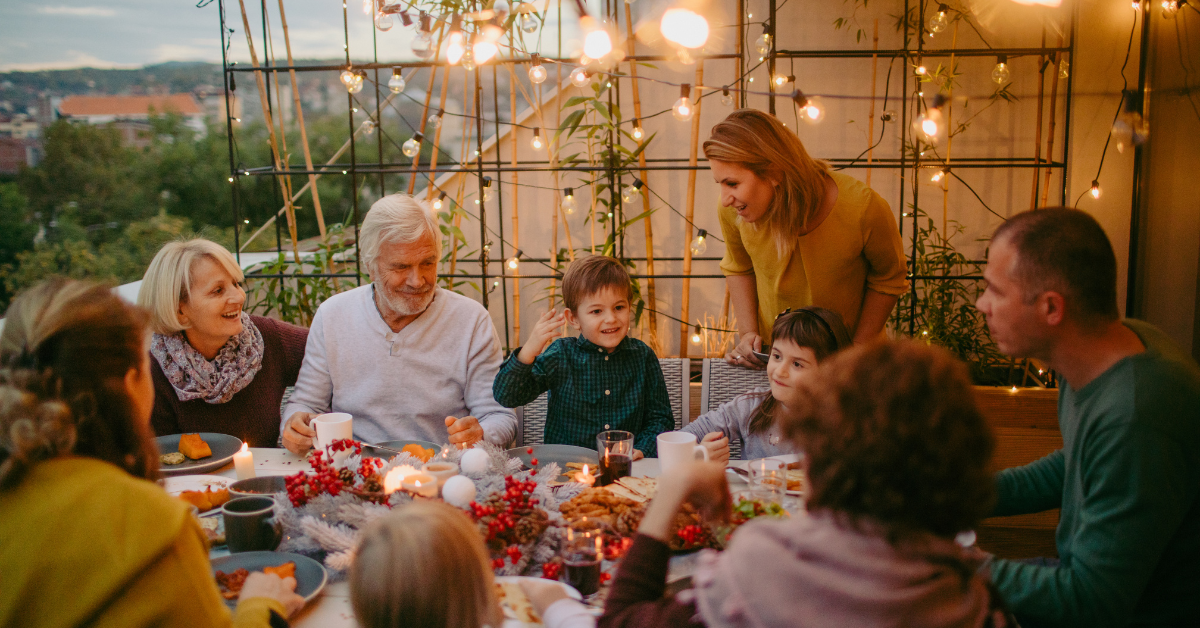 multi-generational family enjoying a meal at the table together with fall vibes