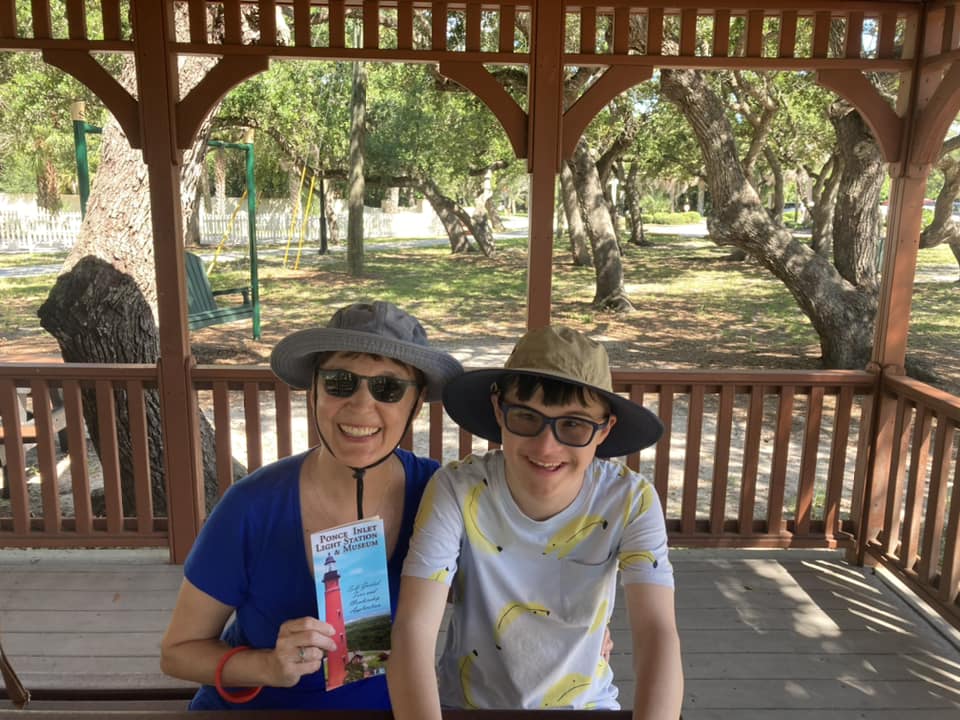 mom and young man wearing hats and smiling at camera