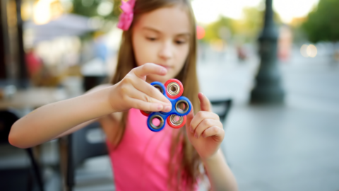 girl spinning fidget spinner