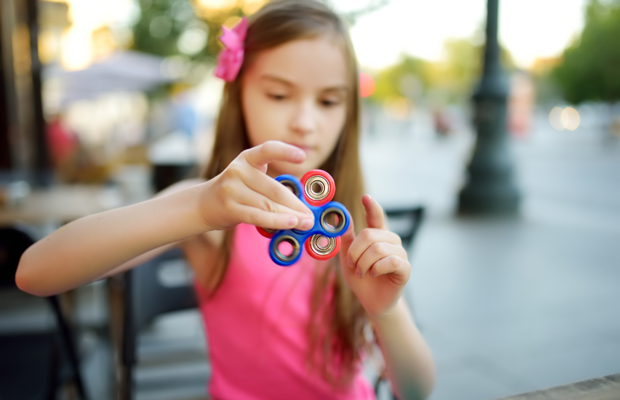 girl spinning fidget spinner