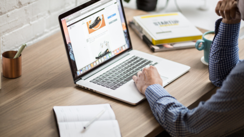 open laptop with male hands using trackpad