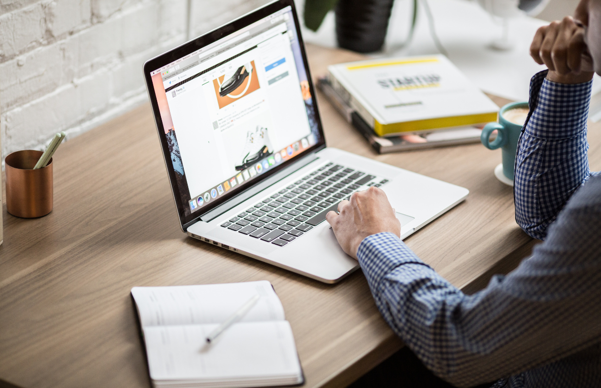 open laptop with male hands using trackpad