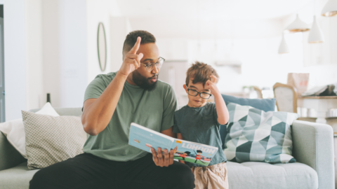 man teaching boy sign language