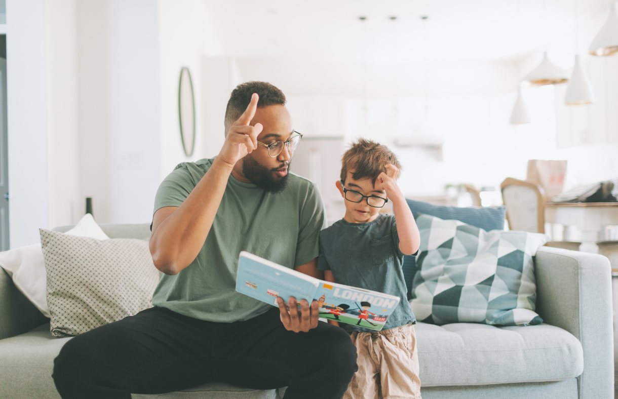 man teaching boy sign language