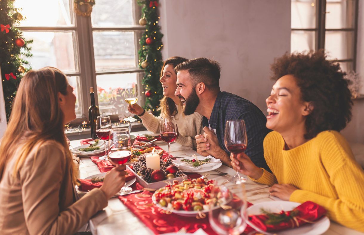 young people sitting at table eating christmas food