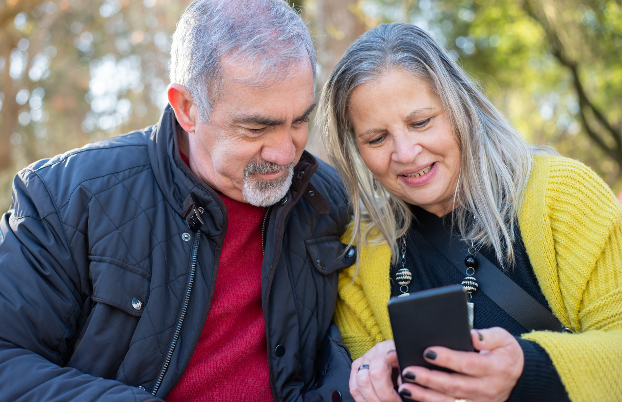 older adult couple looking at smartphone