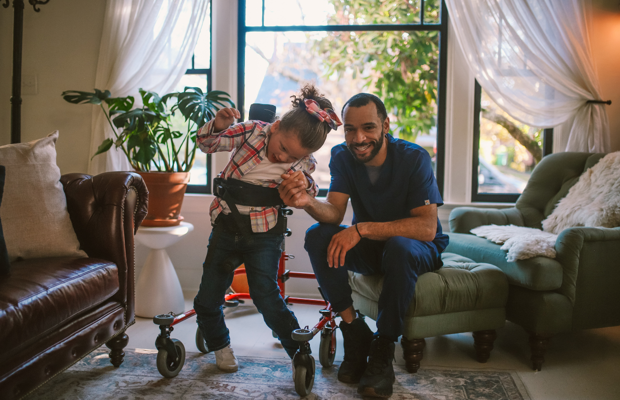 girl in walker with her dad
