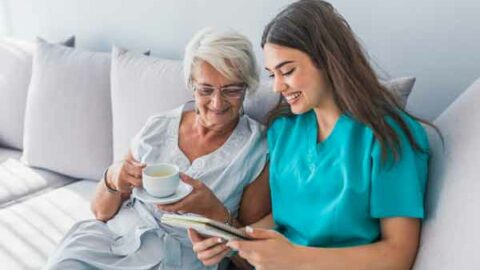 young nurse assisting older female adult