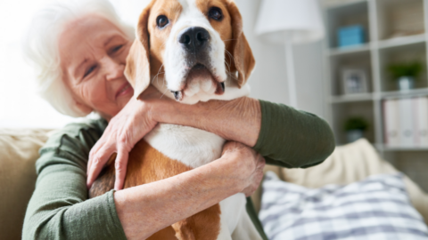 older female adult hugging dog