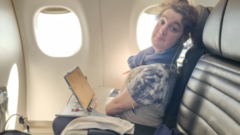 young lady sitting on airplane