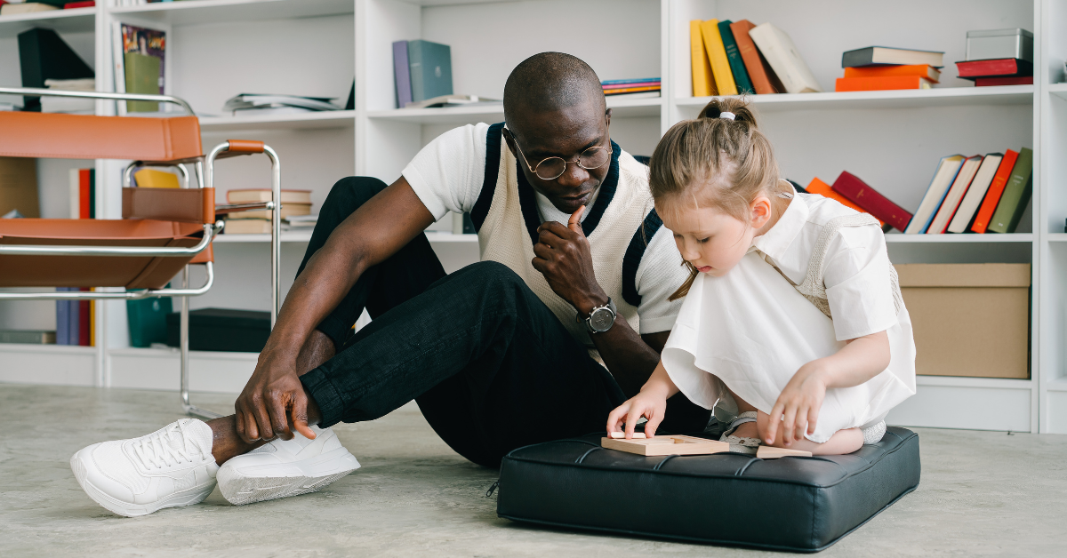 adult teacher working with young girl