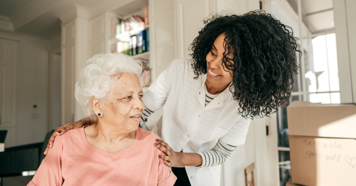 older adult female being assisted by a young female nurse