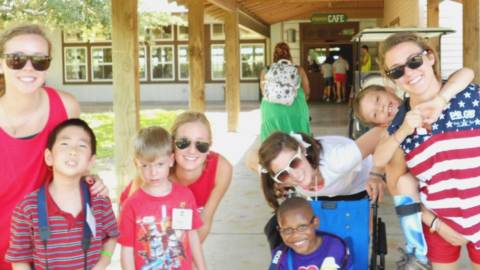 patriotic camp counselors and kids smiling