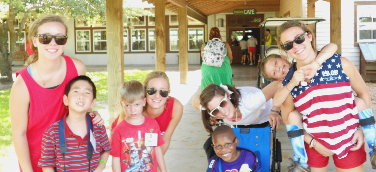 patriotic camp counselors and kids smiling