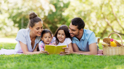 family reading outside