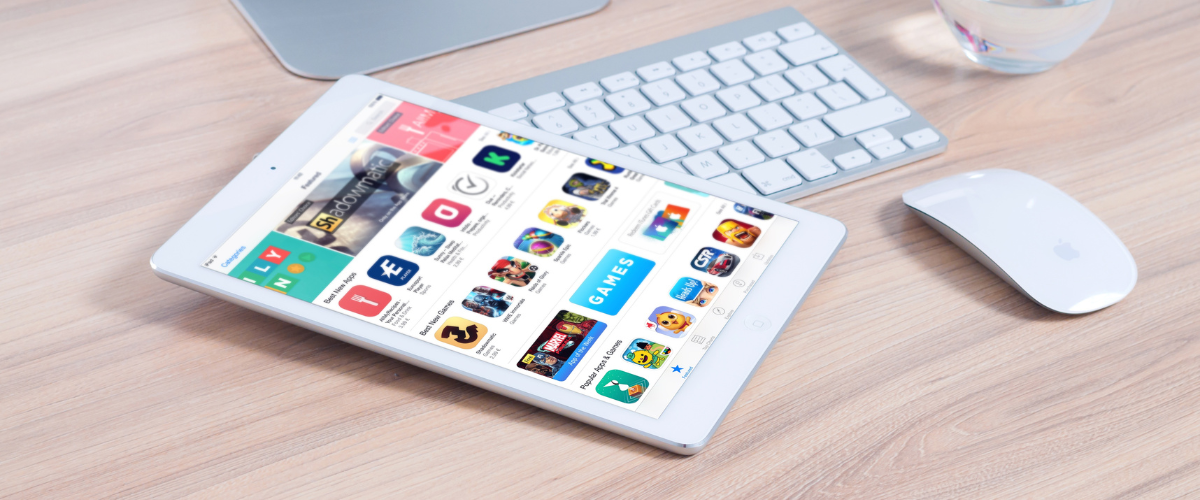 ipad laying on desk with app store displayed on screen