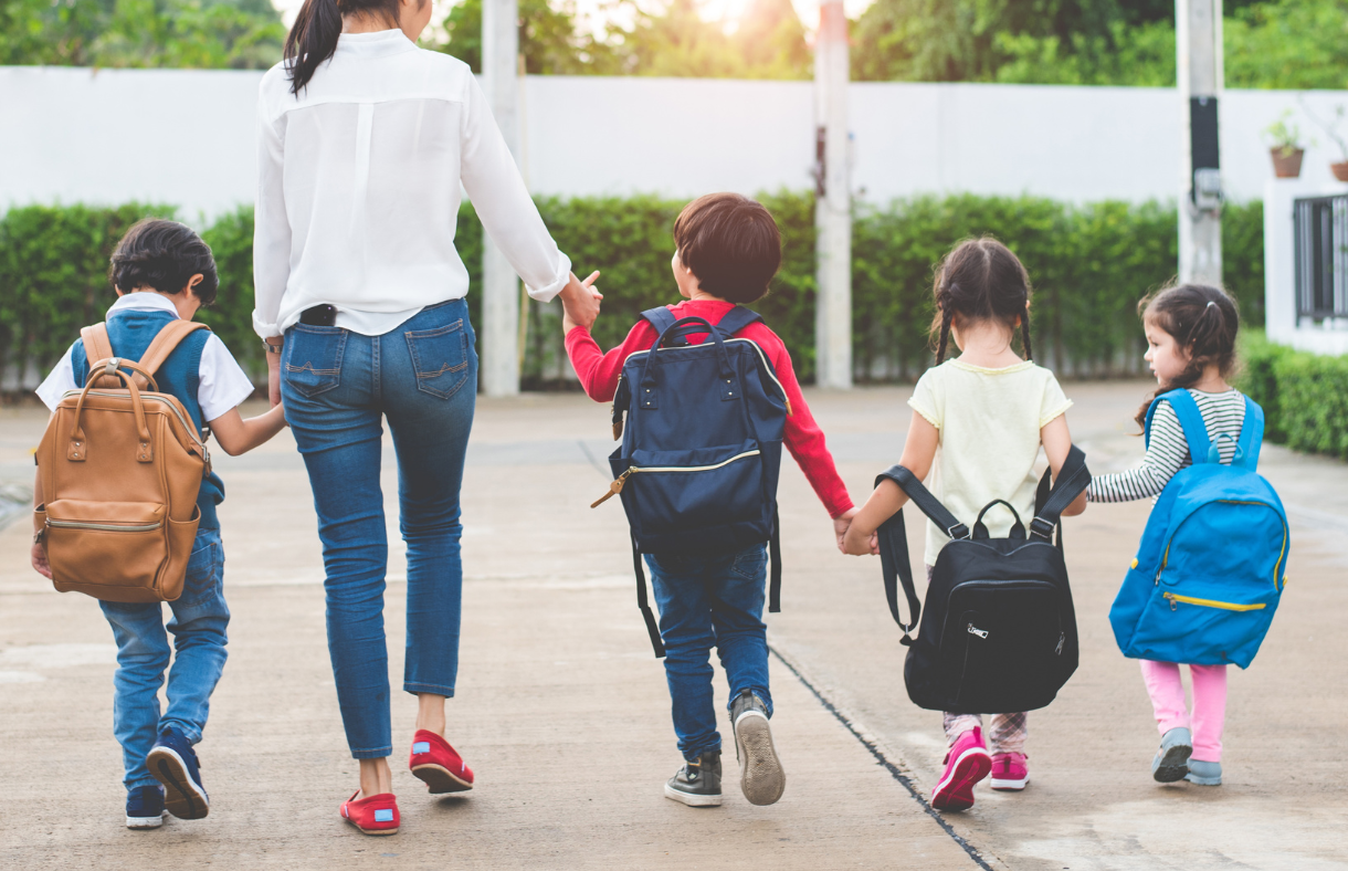 mom walking 4 kids towards school