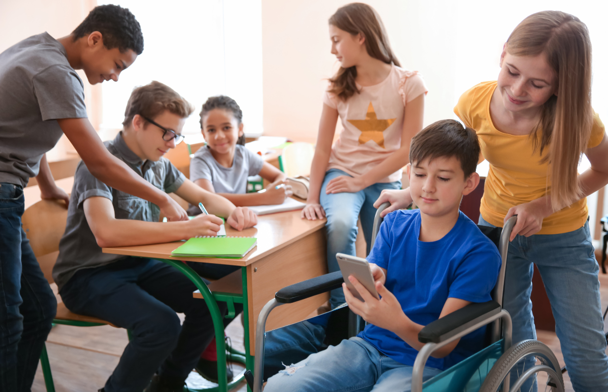 middle school kids in classroom, 1 boy in wheelchair