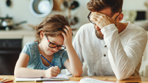 dad helping young daughter with homework