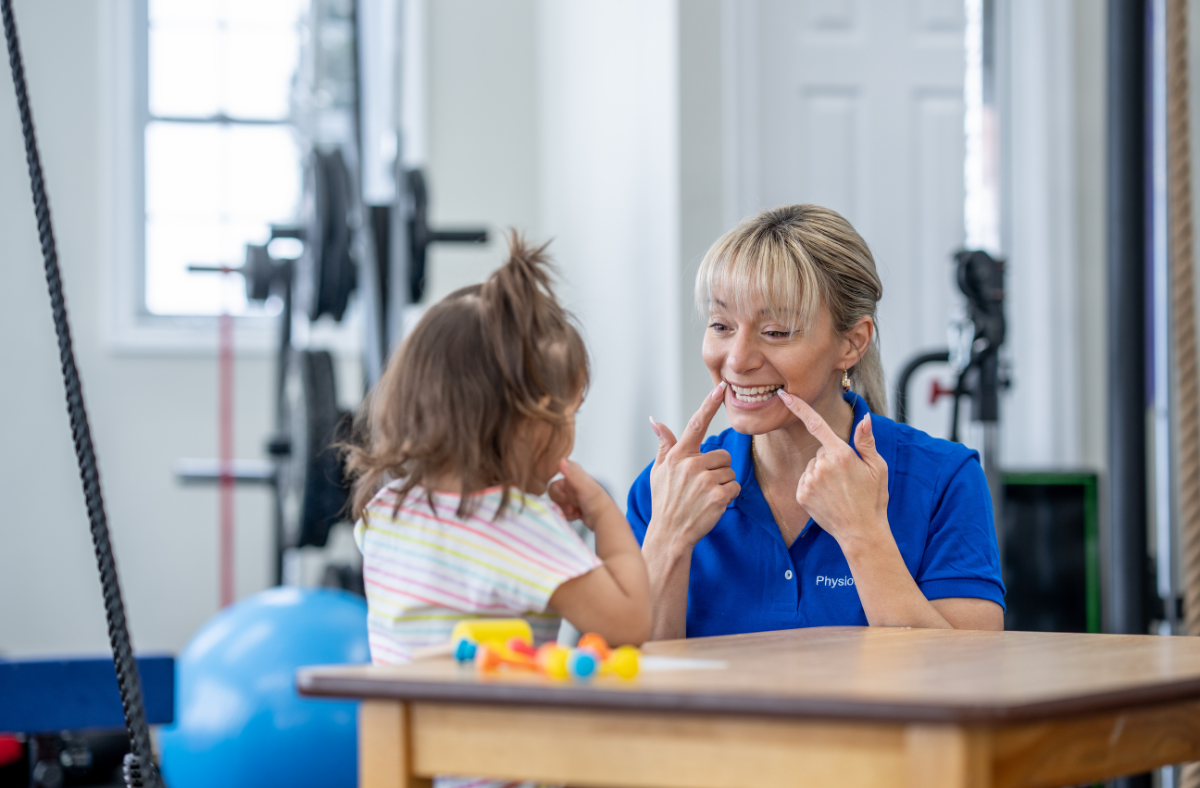 young child with speech therapist