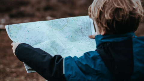 boy looking at paper map