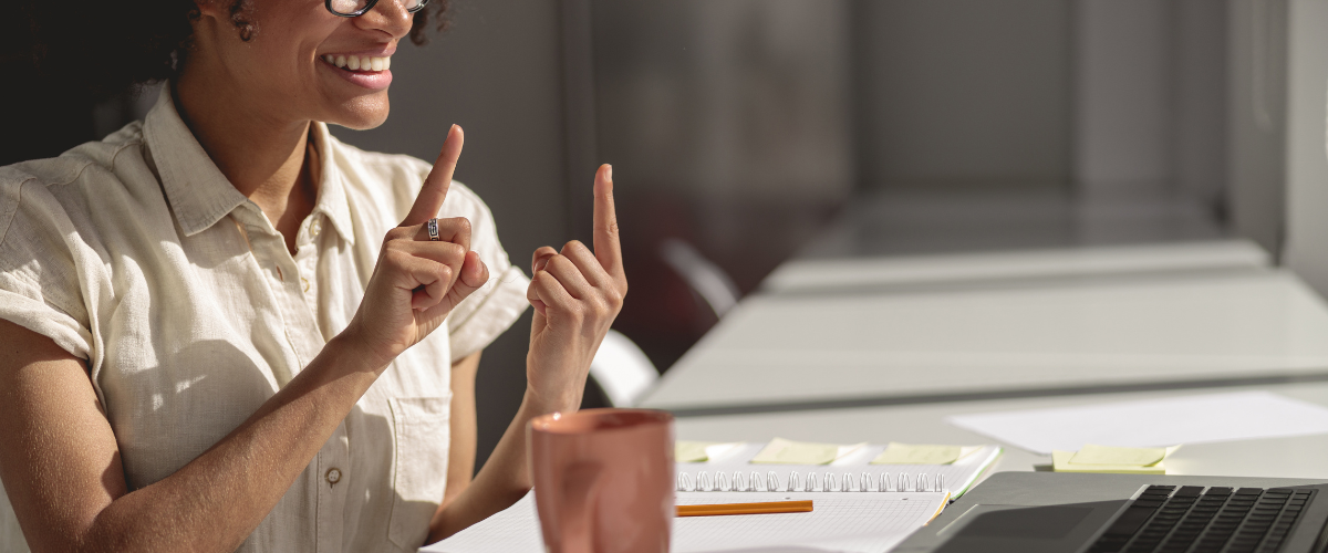 woman at work using sign language to communicate