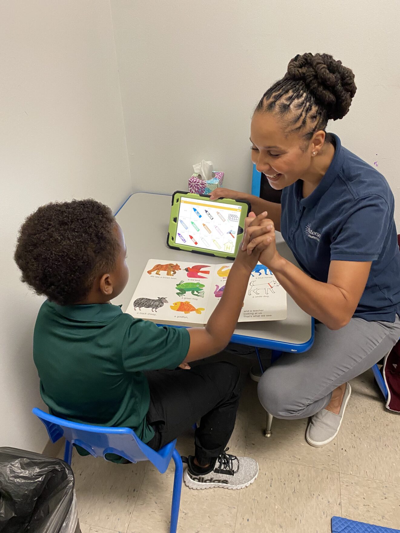 boy sitting with speech therapist
