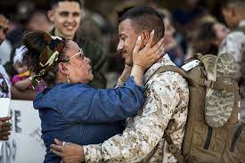 Family member embracing soldier in crowd