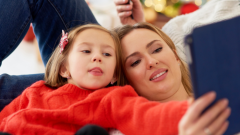 young girl and mom looking at ipad together