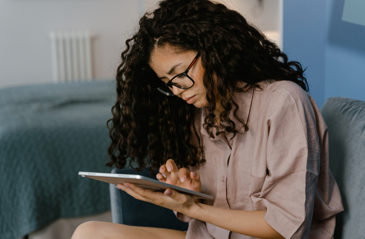 young adult woman touching ipad