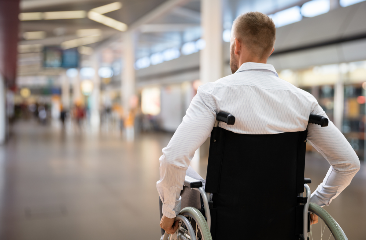 Man using wheelchair in airport