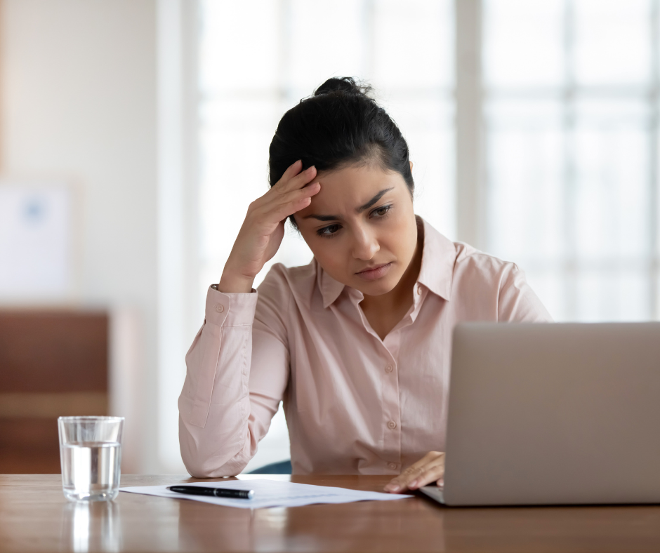 lady looking frustrated in front of laptop