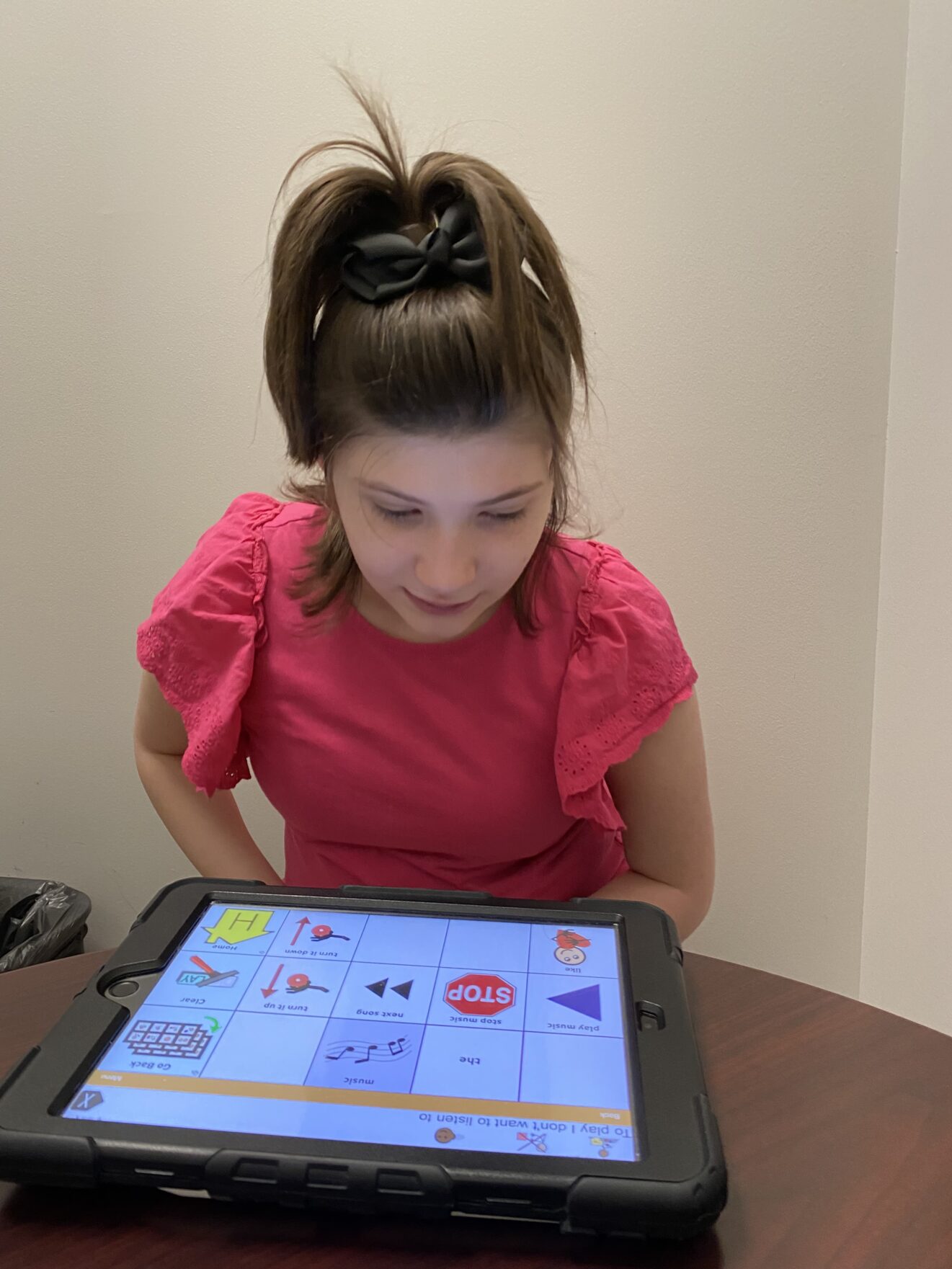 teen girl looking down at ipad