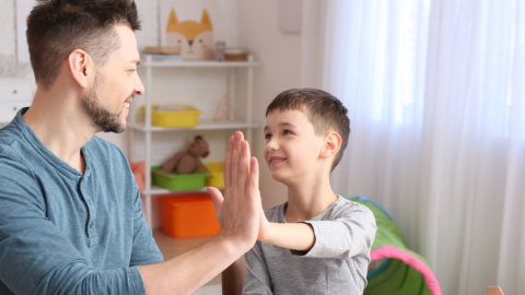 dad and son giving high fives