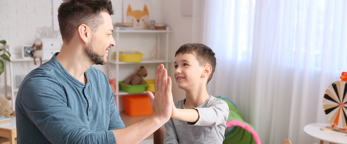 dad and son giving high fives