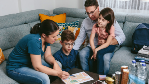 family gathered in living room preparing for emergency