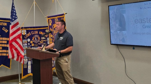 man standing at podium teaching veterans digital navigator skills