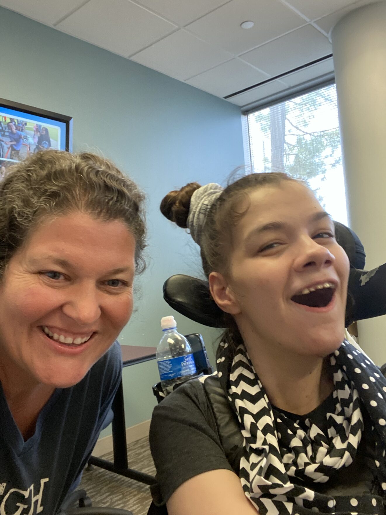 teacher and student smiling at camera